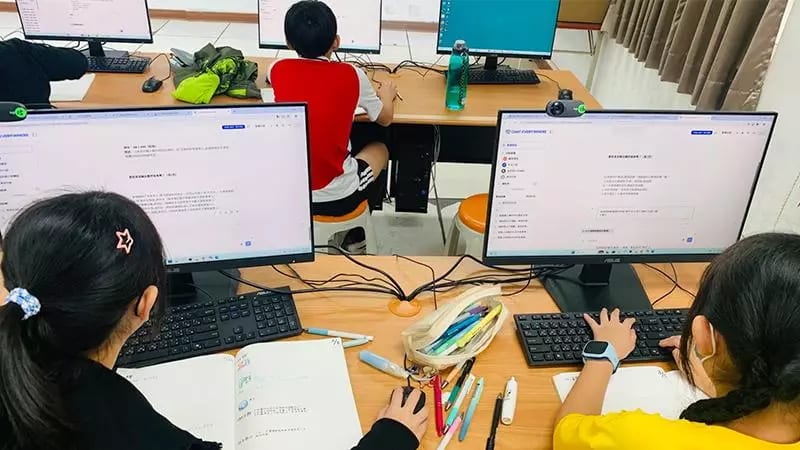 Students using the AI service in a computer classroom